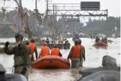  ??  ?? Local residents are rescued by Japanese Self-Defence Force soldiers using a boat at a flooding area caused by a heavy rain in Kuma village, Kumamoto prefecture, southern Japan