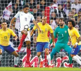  ??  ?? England’s Marcus Rashford (2nd left) in action with Brazil’s Marquinhos (left), Miranda, goalkeeper Alisson and Marcelo during yesterday’s Internatio­nal Friendly match at Wembley Stadium .