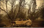  ?? ?? A scorched vehicle rests sits next to a driveway as the Mckinney Fire burns in Klamath National Forest.