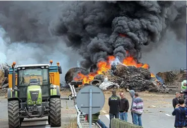  ??  ?? Rule-breakers: French farmers blocking a road last year in protest at falling food prices