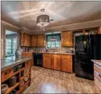  ??  ?? The spacious kitchen has luxury vinyl plank flooring and a central island.