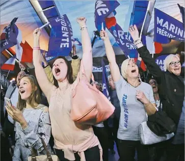  ?? Olivier Hoslet European Pressphoto Agency ?? SUPPORTERS of French presidenti­al candidate Marine Le Pen cheer after hearing the results of the first round of the election, in which Le Pen came in second to Emmanuel Macron. She will face him in a runoff.