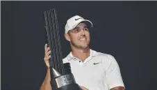  ?? ?? Brooks Koepka with his trophy. Picture: Amer Hilabi/AFP