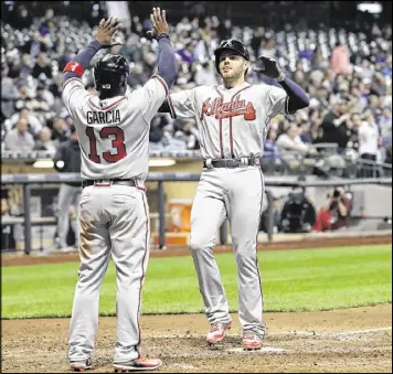  ?? MORRY GASH / ASSOCIATED PRESS ?? Freddie Freeman is among Braves who had a strong April, batting .381 with nine homers and a 1.283 on base plus slugging. One of his home runs (above) came in the ninth inning Friday, giving the Braves a 10-8 victory at Milwaukee.