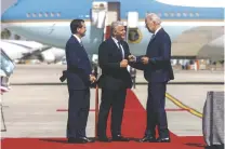  ?? KOBI WOLF/BLOOMBERG NEWS ?? Israel President Isaac Herzog, left, and Prime Minister Yair Lapid greet President Joe Biden as he arrives in Tel Aviv on Wednesday.