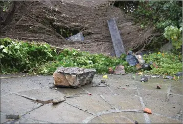  ??  ?? ABOVE: Debris in the back garden of the house on Trafalgar Road in Greystones­e. BELOW: A corner stone with roof slate that landed in the driveway. They were also granted to demolish extensions and newer parts of the building.The planner had not responded to a request for informatio­n at the time of going to press.