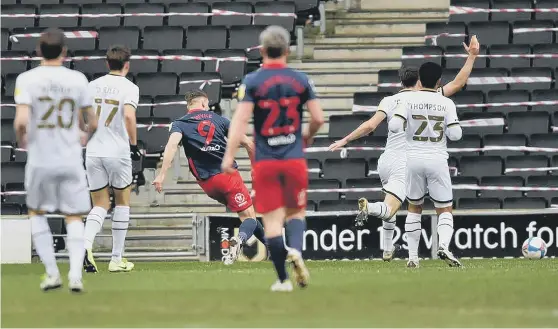  ??  ?? Sunderland striker Charlie Wyke scores his goal against MK Dons.