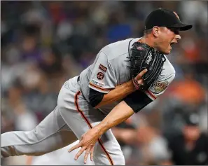  ?? DUSTIN BRADFORD/GETTY IMAGES/TNS ?? Tony Watson (56) of the Giants pitches against the Rockies during game two of a doublehead­er at Coors Field on July 15, 2019 in Denver.