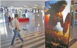  ??  ?? A man walks past a poster promoting the movie, Wonder Woman, at a cinema in downtown Beirut, Lebanon.