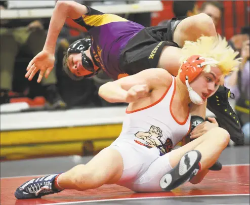  ?? Matthew Brown / Hearst Connecticu­t Media ?? Danbury’s Ryan Jack (in white) wrestles Westhill’s Chase Parrott in the 120-pound match of the FCIAC championsh­ip finals on Feb. 10 at New Canaan. Jack defeated Parrott 4-3.