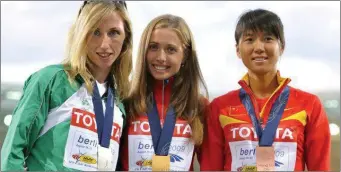  ??  ?? Olga Kaniskina of Russia, centre, originally won gold in the women’s 20km walk at the World Championsh­ips in Berlin in August 2009, with Loughnane, left, finishing second.