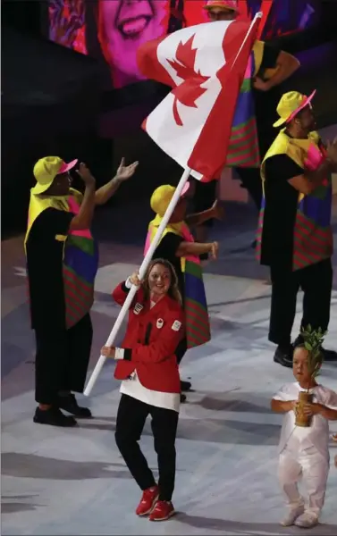  ?? LARS BARON, GETTY IMAGES ?? Rosie MacLennan leads the Canadian team into Maracana Stadium during the Olympic opening ceremony Friday in Rio de Janeiro.