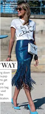  ??  ?? A Paris Fashion Week showgoer works bright accents with a white tee