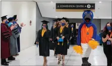  ?? ?? Empire State College’s Blue the Bluebird walks with graduates at the school’s winter 2021 commenceme­nt ceremony.