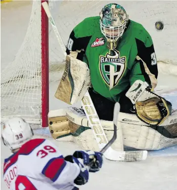  ?? BRUCE EDWARDS/EDMONTON JOURNAL ?? Raiders goaltender Cole Cheveldave makes a save against Brett Pollock on Sunday.