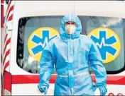  ?? ?? A medical worker wearing protective gear stands outside a hospital for Covid-19 patients in Kiev, Ukraine.