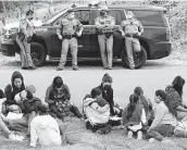  ?? Jerry Lara / Staff photograph­er ?? Texas Department of Public Safety troopers wait on U.S. Border Patrol agents after helping in the detention of migrants just west of La Joya on April 2.