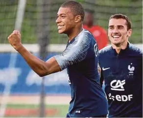  ?? AFP PIC ?? France’s forward Kylian Mbappe (left) celebrates his goal next to compatriot Antoine Griezmann during a training session in preparatio­n for the World Cup.