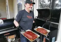  ??  ?? Doug Scheiding experiment­s with smoked meatloaf made from ground beef and Italian sausage.