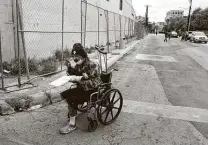  ??  ?? Ralph Resendez stops to eat after receiving food from SA Lights at West Houston and Leona streets.