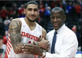  ?? AARON DOSTER - THE ASSOCIATED PRESS ?? FILE - In this Feb. 22, 2020, file photo, Dayton’s Obi Toppin, left, celebrates scoring his 1,000th career point with head coach Anthony Grant after an NCAA college basketball game against Duquesne, in Dayton, Ohio.