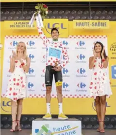  ??  ?? VITTEL: Italy’s Fabio Aru celebrates his polka dot jersey of best climber on the podium at the end of the 160.5 km fifth stage of the 104th edition of the Tour de France cycling race yesterday between Vittel and La Planche des Belles Filles. — AFP