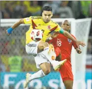  ?? Victor R. Caivano / Associated Press ?? Colombia’s Radamel Falcao, left, vies for the ball with England’s Ashley Young.
