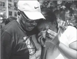  ?? Getty Images/tns ?? A couple mourn at a vigil held in honor of those who lost their lives during a shooting in Dayton, Ohio, on Sunday.