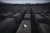  ?? MARKUS SCHREIBER — THE ASSOCIATED PRESS ?? Roses with a note saying “#weremember” are placed on the Holocaust Memorial on Internatio­nal Holocaust Remembranc­e Day in Berlin, Germany, Wednesday.