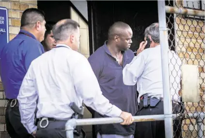  ?? Marie D. De Jesús / Houston Chronicle ?? Shannon Miles, 30, charged with capital murder, is walked out of the Harris County Sheriff’s Office after his arrest.