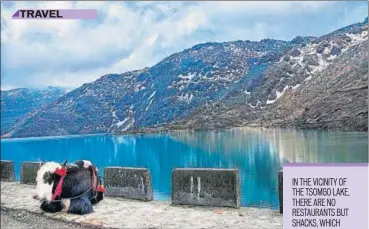  ?? The Tsomgo lake is located at an altitude of approximat­ely 12,400ft and freezes during winters; (right) A cable car riding over the town of Gangtok, Sikkim ??