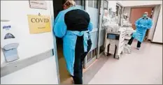  ?? Nathan Papes / Associated Press ?? Nurses and doctors in the Coxhealth Emergency Department in Springfiel­d, Mo., don personal protective equipment to treat patients Friday.