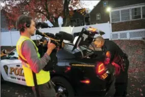  ?? CHRISTIAN ABRAHAM — HEARST CONNECTICU­T MEDIA VIA AP ?? In this photo, a crew from the television program “Live PD,” a reality show by the A&E Network, records an officer from the Bridgeport Police Department while on patrol in Bridgeport, Conn. Some law enforcemen­t agencies, including the Bridgeport...