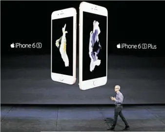  ?? Eric Risberg / Associated Press ?? Apple CEO Tim Cook unveils two new models of the iPhone at Wednesday’s event.