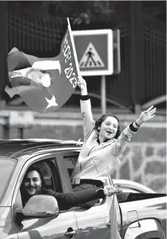  ?? Associated Press ?? ■ Supporters of Turkey’s President and ruling Justice and Developmen­t Party, or AKP, leader Recep Tayyip Erdogan celebrate Sunday outside his official residence in Istanbul. Early partial results in Turkey’s presidenti­al elections Sunday showed...