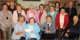  ??  ?? At the presentati­on of a €1,000 cheque to Castleisla­nd Day Care Centre from Castleisla­nd Care Players were seated: Marcella Finn, nurse manager, Castleisla­nd Day Care Centre receiving the cheque from Hannah Hickey on behalf of the card players with:...
