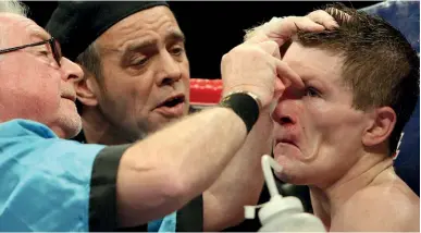  ??  ?? PROBLEMATI­C: Mick Williamson goes to work on Hatton’s delicate eyes while Billy Graham offers advice to his fighter