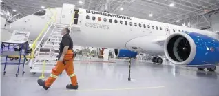  ?? — AFP ?? A worker walks past the CS300 Aircraft in the hangar prior to its’ test flight in Mirabel, Quebec.