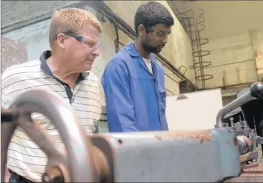  ?? PHOTO: ALAN TAYLOR ?? Exective Director Cape Engineers and Founders Assocation with apprentice Faizel Jurams working at CME Precision. Apprentice­ships are becoming very attractive because of their demand and high likelihood of getting a job upon creation.