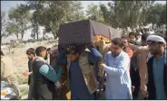  ?? (AP) ?? At a funeral Wednesday in Jalalabad, Afghanista­n, relatives carry the casket of a woman killed Tuesday in attacks claimed by the Islamic State.