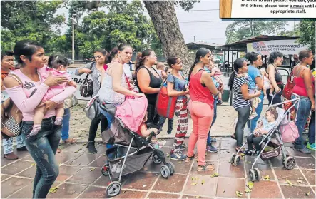  ??  ?? Venezuelan­s wait to be vaccinated against measles in Cucuta, Colombia.
LEFT
A sign at the speciality clinic at Children’s Minnesota in Minneapoli­s last year alerts people to a measles outbreak in the area.