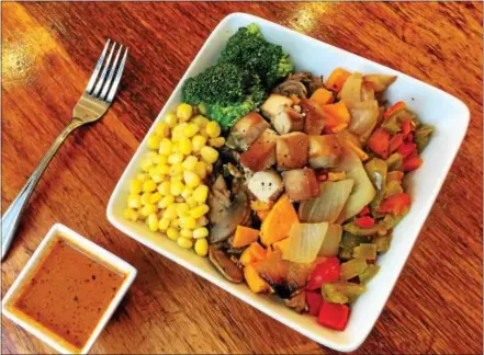  ?? PHOTO COURTESY OF PLANTPURE CAFÈ ?? Tofu tops this food bowl from PlantPure Café in Philadelph­ia.