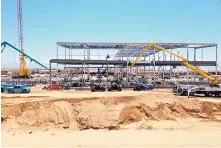  ?? COURTESY OF FACEBOOK ?? The first building of Facebook’s Los Lunas data center is seen rising out of the 330-acre campus site in July. Work on a second of six planned buildings has begun with the pouring of foundation concrete.