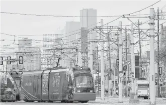  ?? Karen Warren / Houston Chronicle file ?? A Metropolit­an Transit Authority train cuts across Harrisburg Boulevard as it travels near the Harrisburg overpass on the Purple line, which averaged nearly 5,900 riders daily in March.