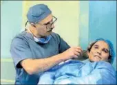  ?? AP ?? Dr Abbas alsahan makes surgical marks around the damaged ear of Saja Saleem, before her plastic surgery in Baghdad. She lost her eyesight, right arm and an ear in an explosion.