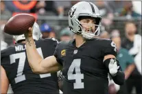  ?? RICK SCUTERI — ASSOCIATED PRESS ?? Las Vegas quarterbac­k Derek Carr throws against the Eagles Sunday. Carr completed 91.1percent of his pass attempts in a 33-22Raiders win.