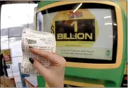  ?? KEITH SRAKOCIC — THE ASSOCIATED PRESS ?? A patron, who did not want to give her name, shows the ticket she had just bought for the Mega Millions lottery drawing at the lottery ticket vending kiosk in a Smoker Friendly store, Friday, Jan. 22, 2021, in Cranberry Township, Pa.