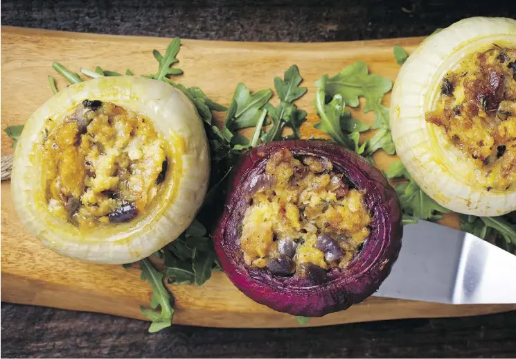  ?? PHOTOS: DEB LINDSEY/FOR THE WASHINGTON POST ?? These onions stuffed with herbs and cheese can be prepared ahead of time and reheated just before serving to guests.