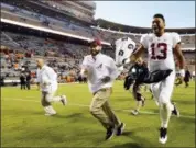  ?? WADE PAYNE — THE ASSOCIATED PRESS ?? Alabama quarterbac­k Tua Tagovailoa (13) celebrates as he leaves the field after an NCAA college football game against Tennessee Saturday, Oct. 20, 2018, in Knoxville, Tenn. Alabama won 58-21.