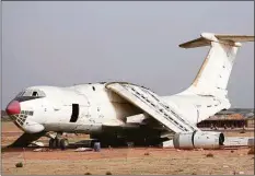  ?? Associated Press ?? An abandoned plane, an Ilyushin Il-76, once tied to arms smuggler Viktor Bout, is being dismantled at the old airfield of Umm al-Quwain, United Arab Emirates. The hulking, Soviet-era cargo plane has sat for decades under the blazing sun in this least-populated corner of the United Arab Emirates, its four jet engines silent after years in the employ of a Russian gunrunner infamously known as the "Merchant of Death."